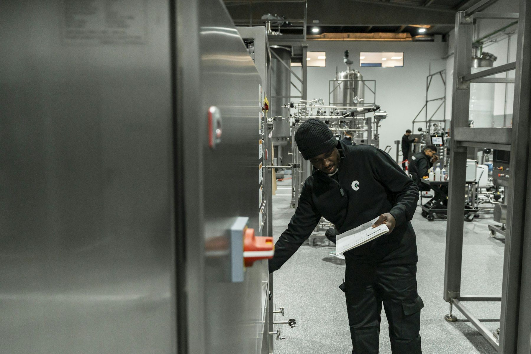 Technician inspecting equipment on a production floor